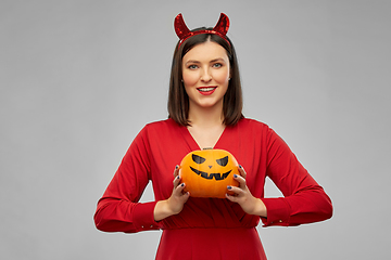 Image showing woman in halloween costume of devil with pumpkin