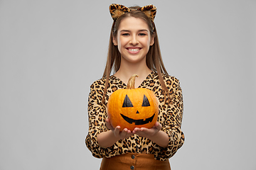 Image showing woman in halloween costume of leopard with pumpkin