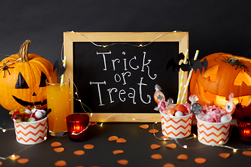 Image showing pumpkins, candies and halloween decorations