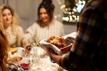 Image showing happy friends having christmas dinner at home