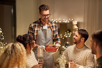 Image showing happy friends having christmas dinner at home