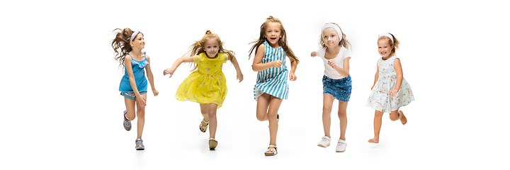 Image showing Happy little caucasian kids jumping and running isolated on white background