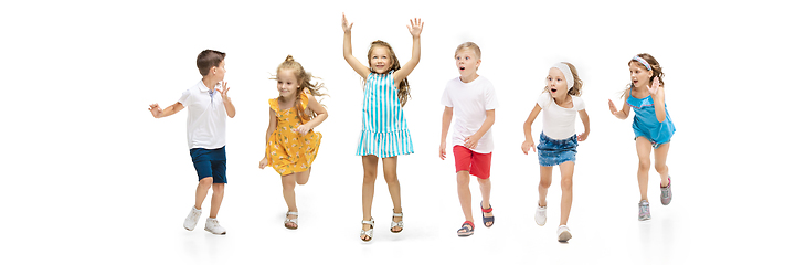 Image showing Happy little caucasian kids jumping and running isolated on white background