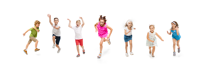 Image showing Happy little caucasian kids jumping and running isolated on white background