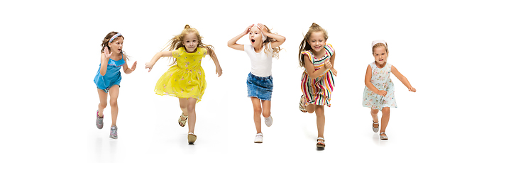 Image showing Happy little caucasian kids jumping and running isolated on white background