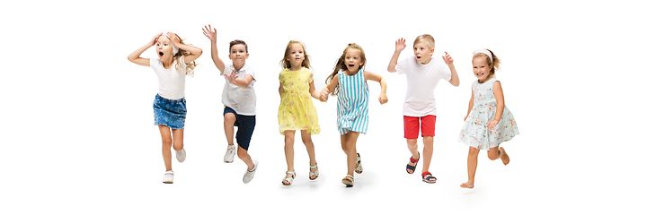 Image showing Happy little caucasian kids jumping and running isolated on white background