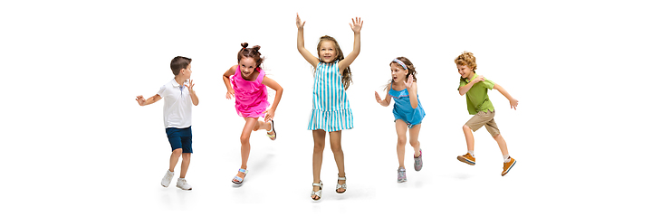 Image showing Happy little caucasian kids jumping and running isolated on white background