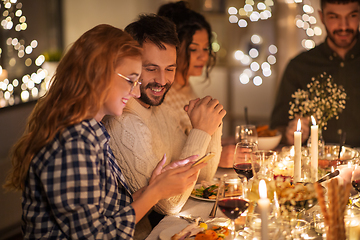 Image showing friends with cellphone having dinner party at home