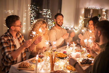 Image showing happy friends having christmas dinner at home