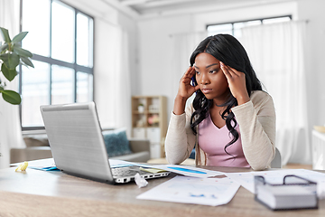 Image showing stressed woman with papers working at home office