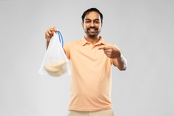 Image showing happy man holding reusable string bag with bananas