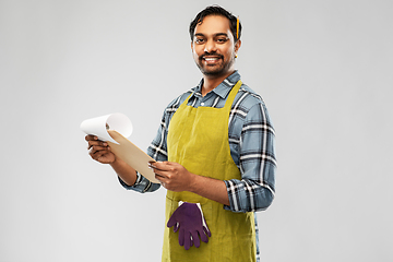 Image showing happy indian gardener or farmer with clipboard