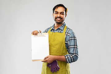 Image showing happy indian gardener or farmer showing clipboard