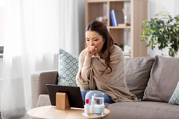 Image showing sick woman having video call on tablet pc at home