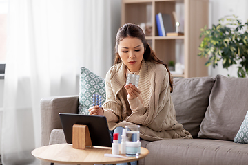 Image showing sick woman with medicine has video consultation