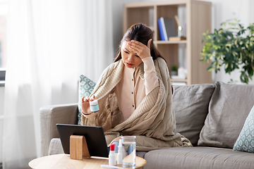 Image showing sick woman with medicine has video consultation