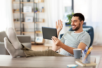 Image showing man with tablet pc having video call at home