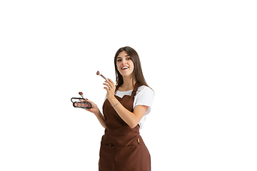 Image showing Young woman, visagiste with cosmetics isolated on white studio background