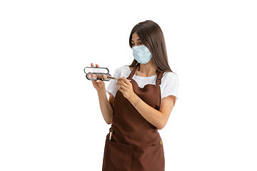 Image showing Young woman, visagiste with cosmetics isolated on white studio background