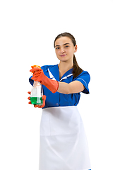 Image showing Portrait of female made, cleaning worker in white and blue uniform isolated over white background