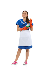 Image showing Portrait of female made, cleaning worker in white and blue uniform isolated over white background