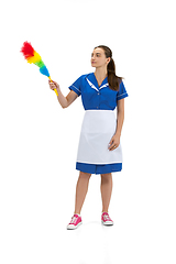 Image showing Portrait of female made, cleaning worker in white and blue uniform isolated over white background