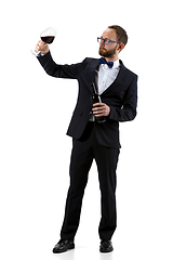 Image showing Portrait of male sommelier in suit isolated over white background