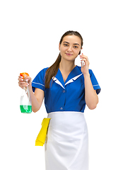 Image showing Portrait of female made, cleaning worker in white and blue uniform isolated over white background