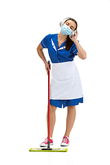 Image showing Portrait of female made, cleaning worker in white and blue uniform isolated over white background