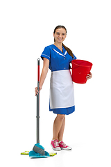 Image showing Portrait of female made, cleaning worker in white and blue uniform isolated over white background