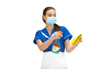 Image showing Portrait of female made, cleaning worker in white and blue uniform isolated over white background