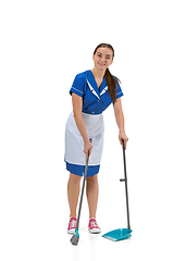 Image showing Portrait of female made, cleaning worker in white and blue uniform isolated over white background