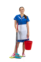 Image showing Portrait of female made, cleaning worker in white and blue uniform isolated over white background