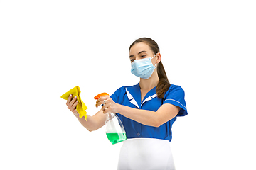 Image showing Portrait of female made, cleaning worker in white and blue uniform isolated over white background