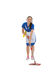 Image showing Portrait of female made, cleaning worker in white and blue uniform isolated over white background