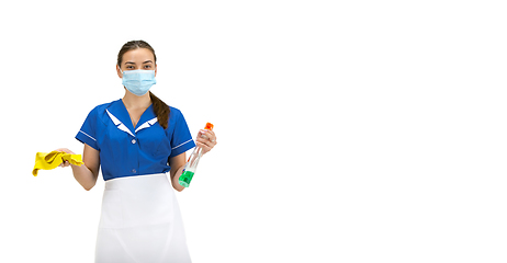 Image showing Portrait of female made, cleaning worker in white and blue uniform isolated over white background