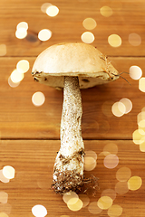 Image showing brown cap boletus mushroom on wooden background