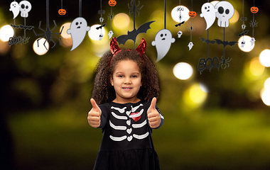 Image showing girl in black dress and devil's horns on halloween