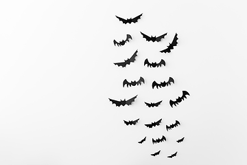 Image showing flock of black paper bats over white background