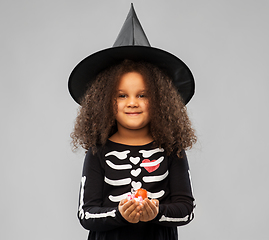Image showing girl with candies trick-or-treating on halloween