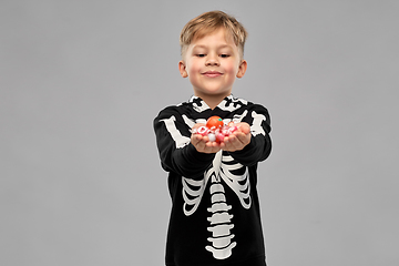 Image showing boy with candies trick-or-treating on halloween