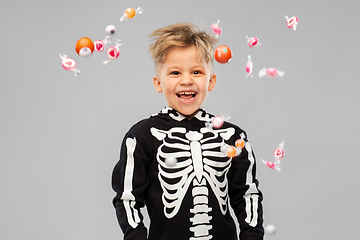 Image showing boy with candies trick-or-treating on halloween