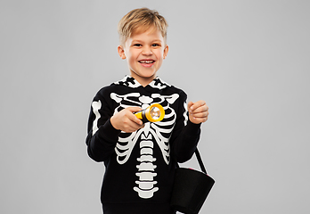 Image showing happy with candies and flashlight on halloween