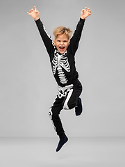 Image showing happy boy in halloween costume of skeleton jumping