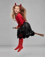 Image showing girl in halloween costume flying with witch broom