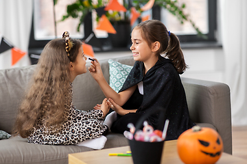 Image showing girls doing face painting on halloween at home