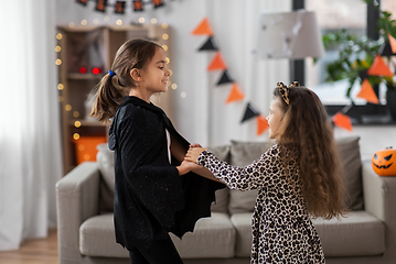 Image showing girls in halloween costumes dancing at home