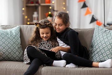 Image showing girls in halloween costumes with tablet pc at home