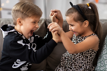 Image showing kids in halloween costumes having fun at home