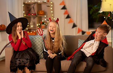 Image showing kids in halloween costumes playing at home